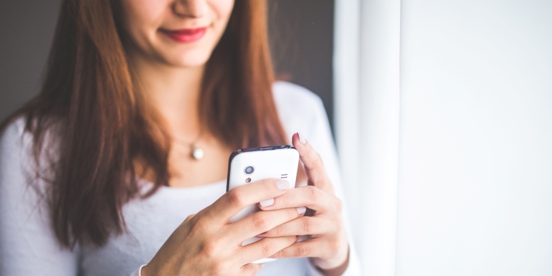 Woman holds a smartphone