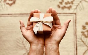 person holding out a gift for green thanksgiving